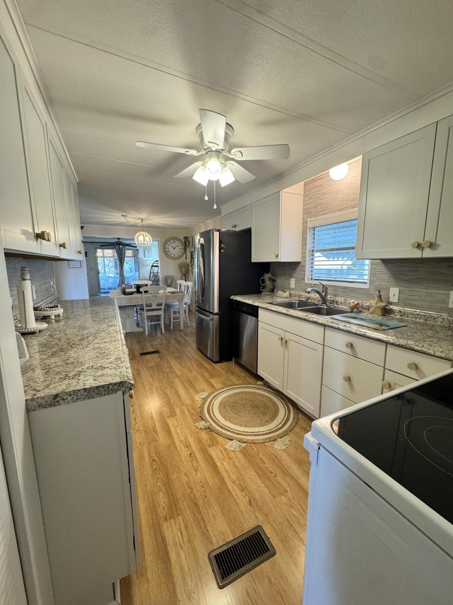 17 Verde Vista Fort Pierce, FL 34951 - Photo 10 of 35 a kitchen with stainless steel appliances granite countertop a sink a stove and a refrigerator