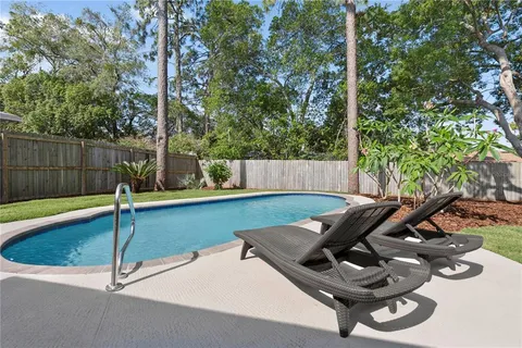 a view of a backyard with chairs