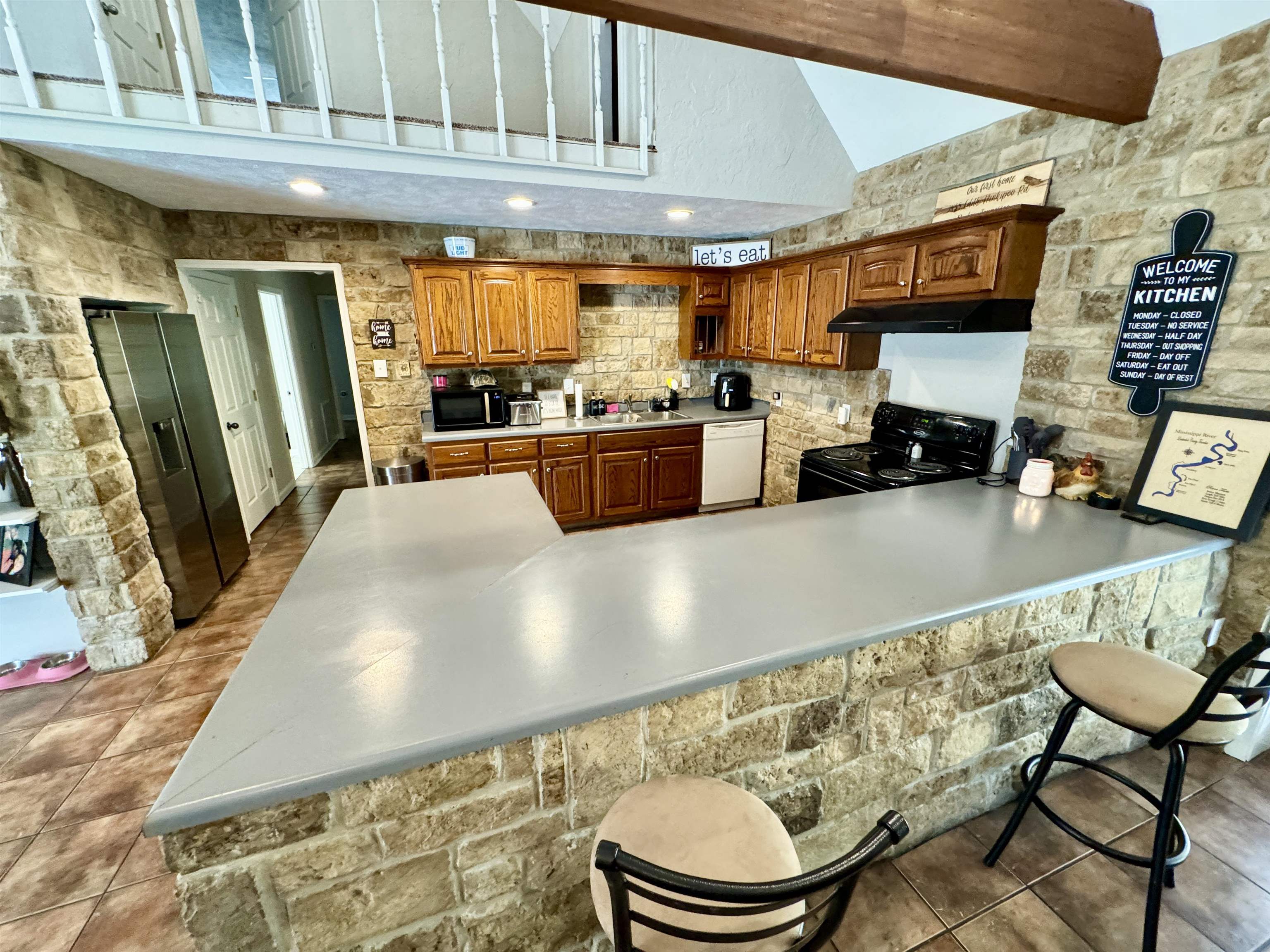2455 Edith-Nankipoo Road Ripley, TN 38063 - Photo 11 of 29 a kitchen with stainless steel appliances kitchen island granite countertop a sink and a refrigerator