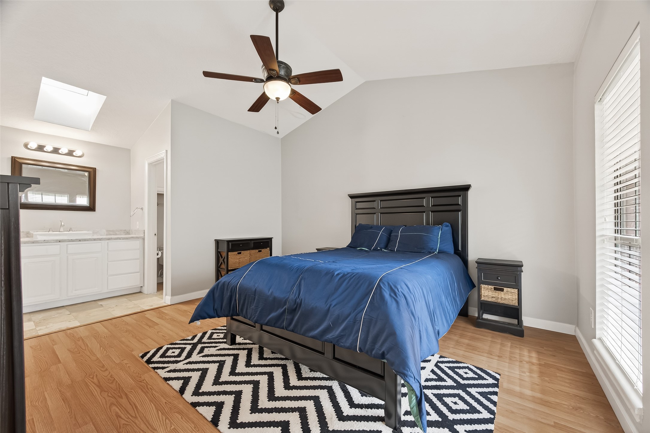 2211 South Kirkwood Road, Unit 42 Houston, TX 77077 - Photo 24 of 34 a bedroom with a bed and wooden floor