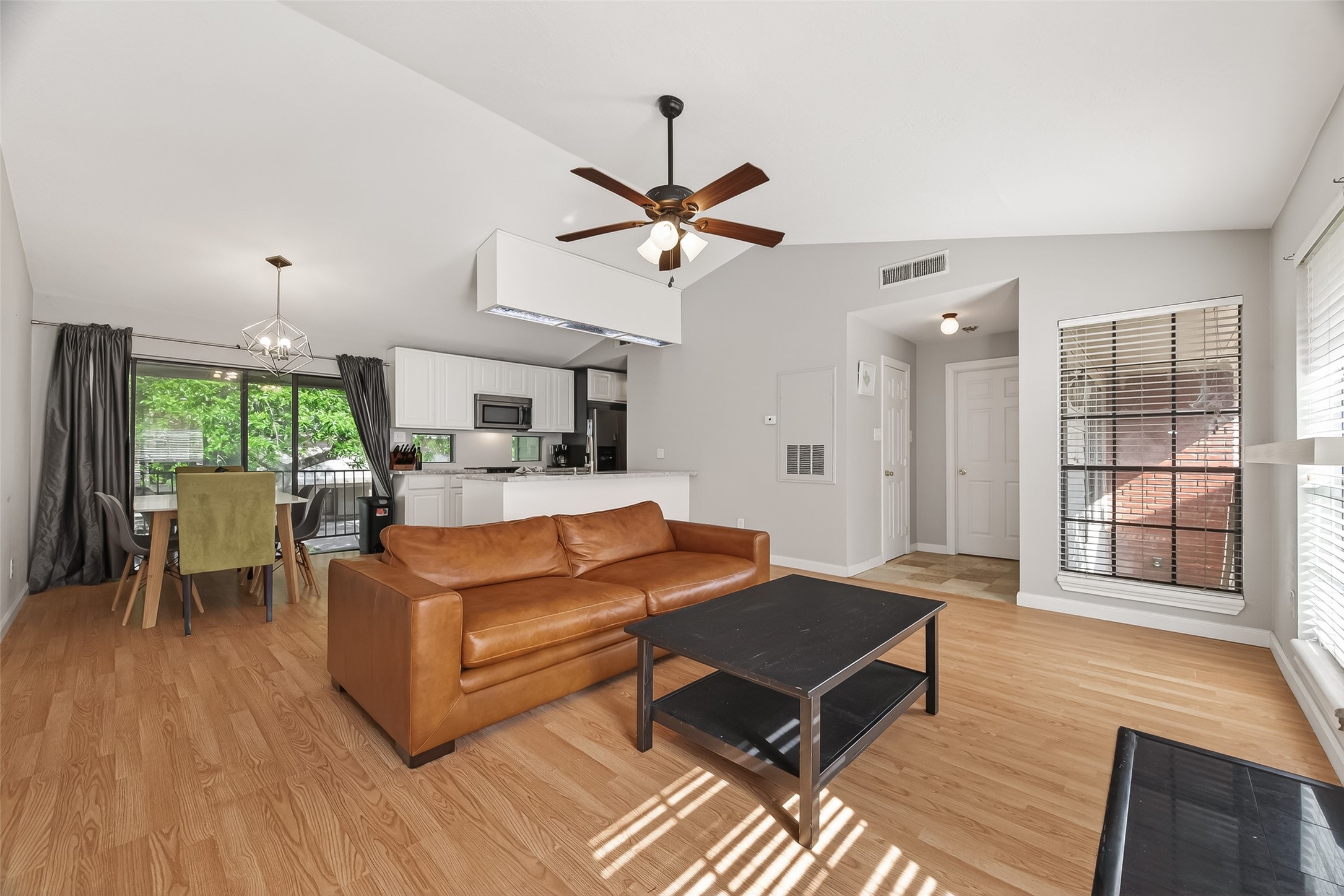 2211 South Kirkwood Road, Unit 42 Houston, TX 77077 - Photo 5 of 34 a living room with furniture ceiling fan and a wooden floor