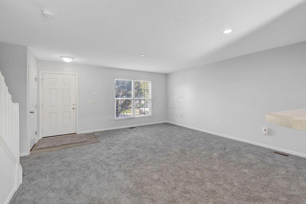 6345 Needletail Road, Unit 24634 Columbus, OH 43230 - Photo 6 of 58 • New gray carpet ~ 2021 • Gray painted walls • Ceiling light • Can lighting in Dining Area • 2” blinds