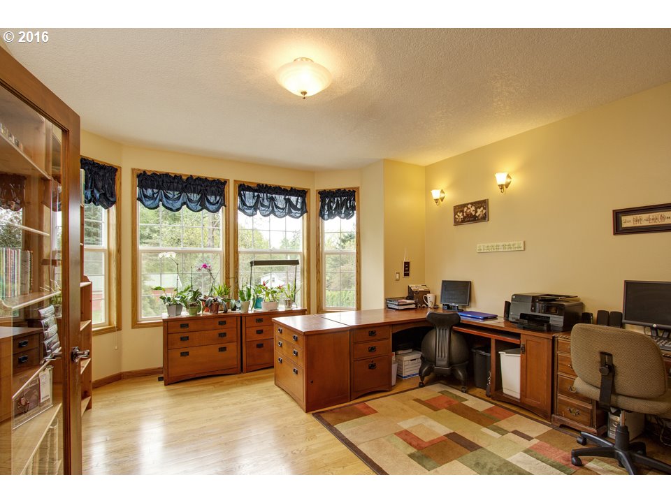 2686 Southeast Territorial Road Canby, OR 97013 - Photo 14 of 32 a living room with furniture a flat screen tv and a floor to ceiling window
