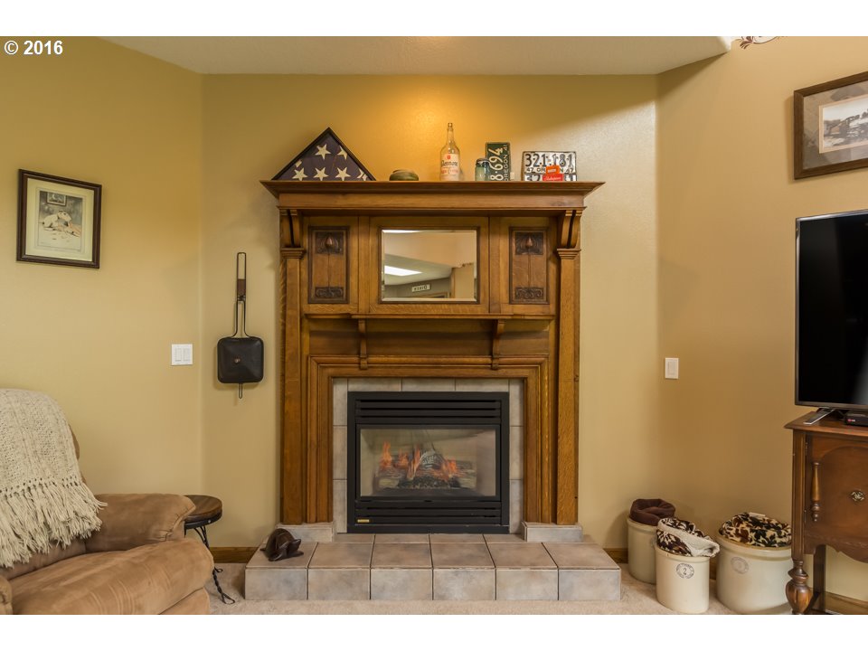 2686 Southeast Territorial Road Canby, OR 97013 - Photo 4 of 32 a living room with furniture a flat screen tv and a fireplace
