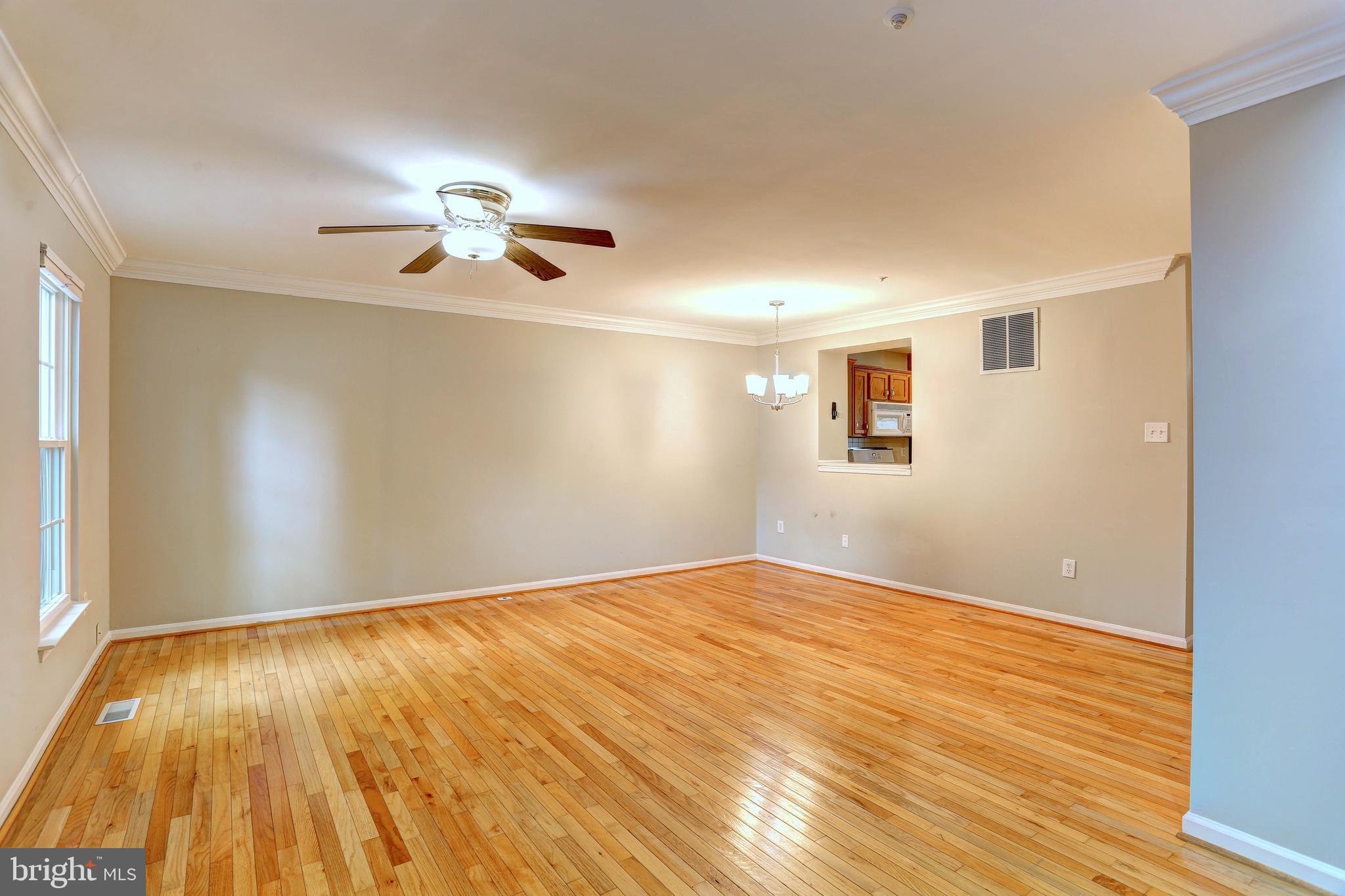 6136 Starburn Path Columbia, MD 21045 - Photo 10 of 35 a view of empty room with wooden floor and fan