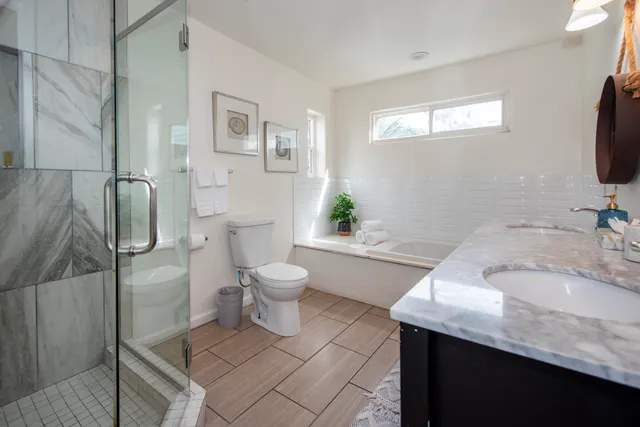 a white toilet sitting next to a bathroom sink