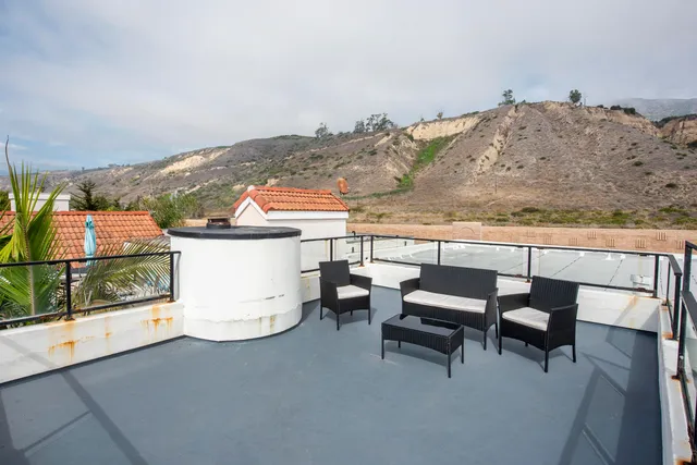 a view of a terrace with furniture and mountain view
