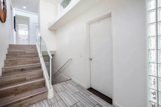 a view of entryway with wooden floor and stairs