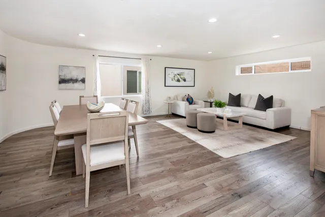 a living room with furniture wooden floor and a window