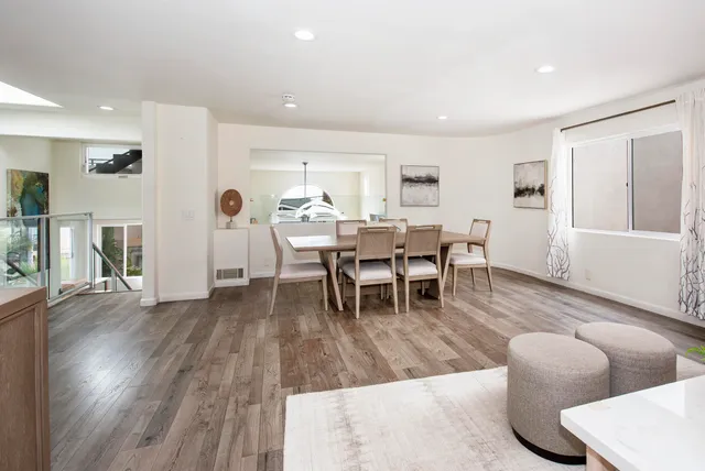a living room with furniture wooden floor and a table