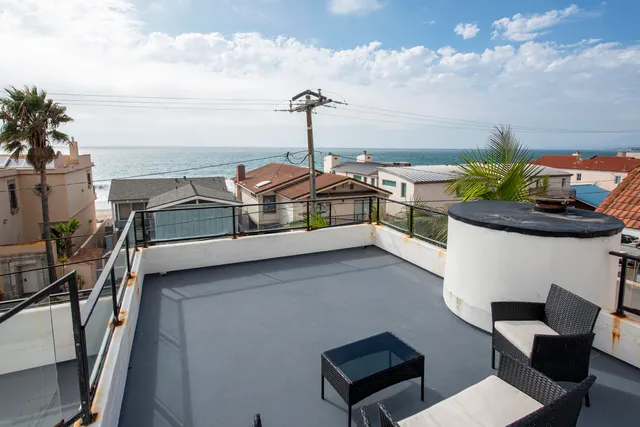 a balcony with a table and chairs