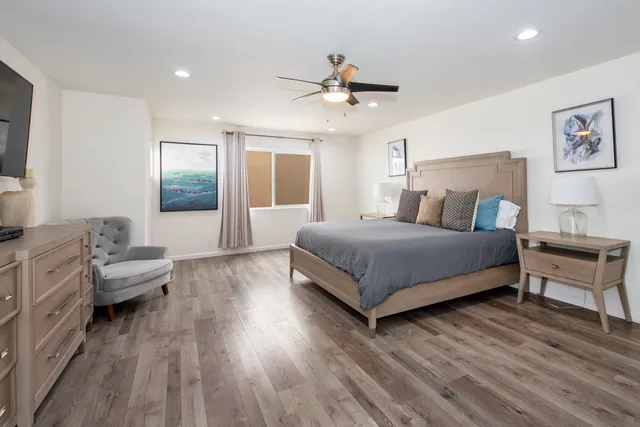 a bedroom with a bed and wooden floor