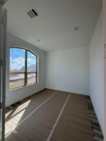 an empty room with a empty space and windows