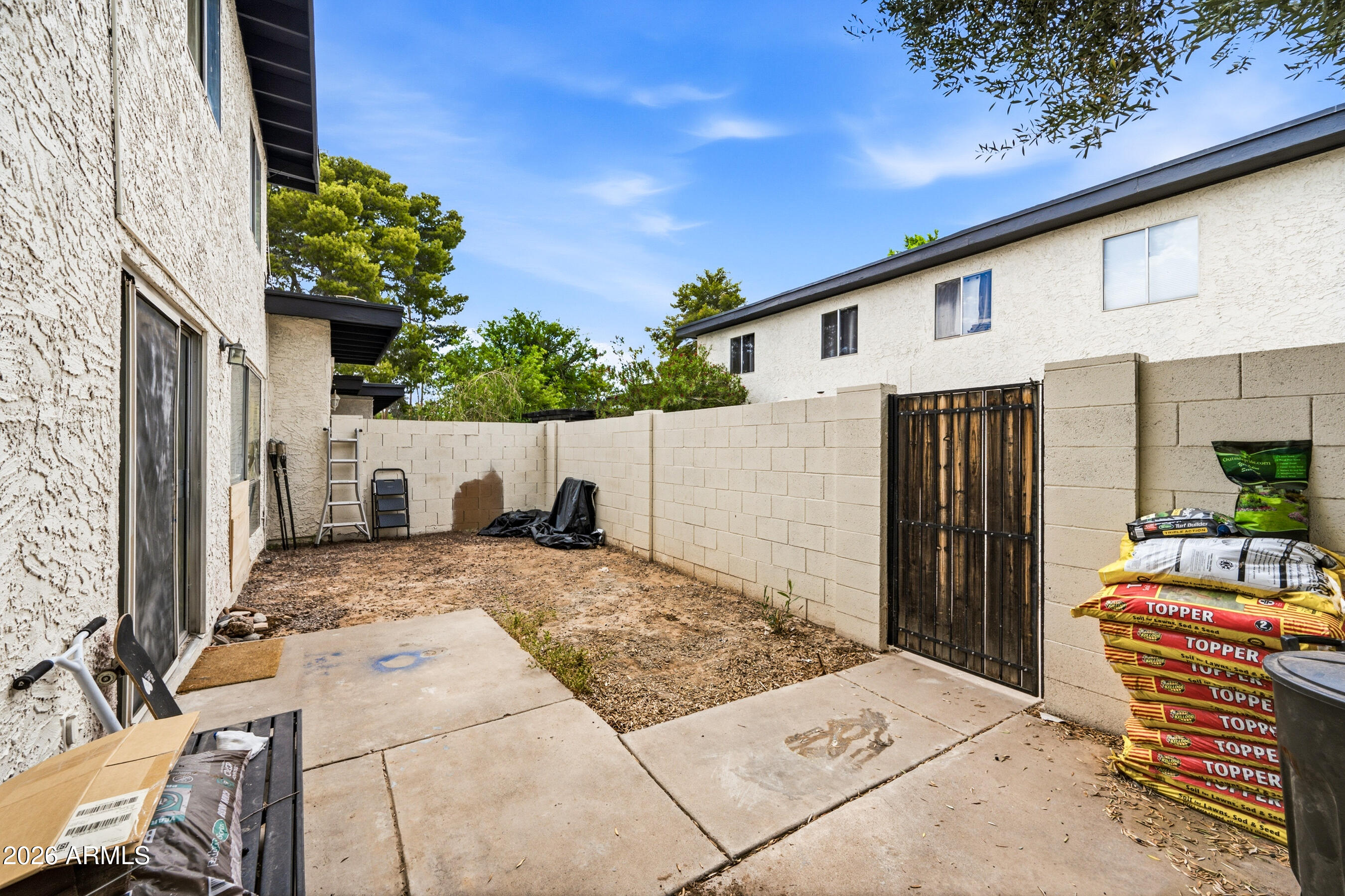 1051 South Dobson Road, Unit 187 Mesa, AZ 85202 - Photo 18 of 18 a view of backyard with a table and chairs and potted plants