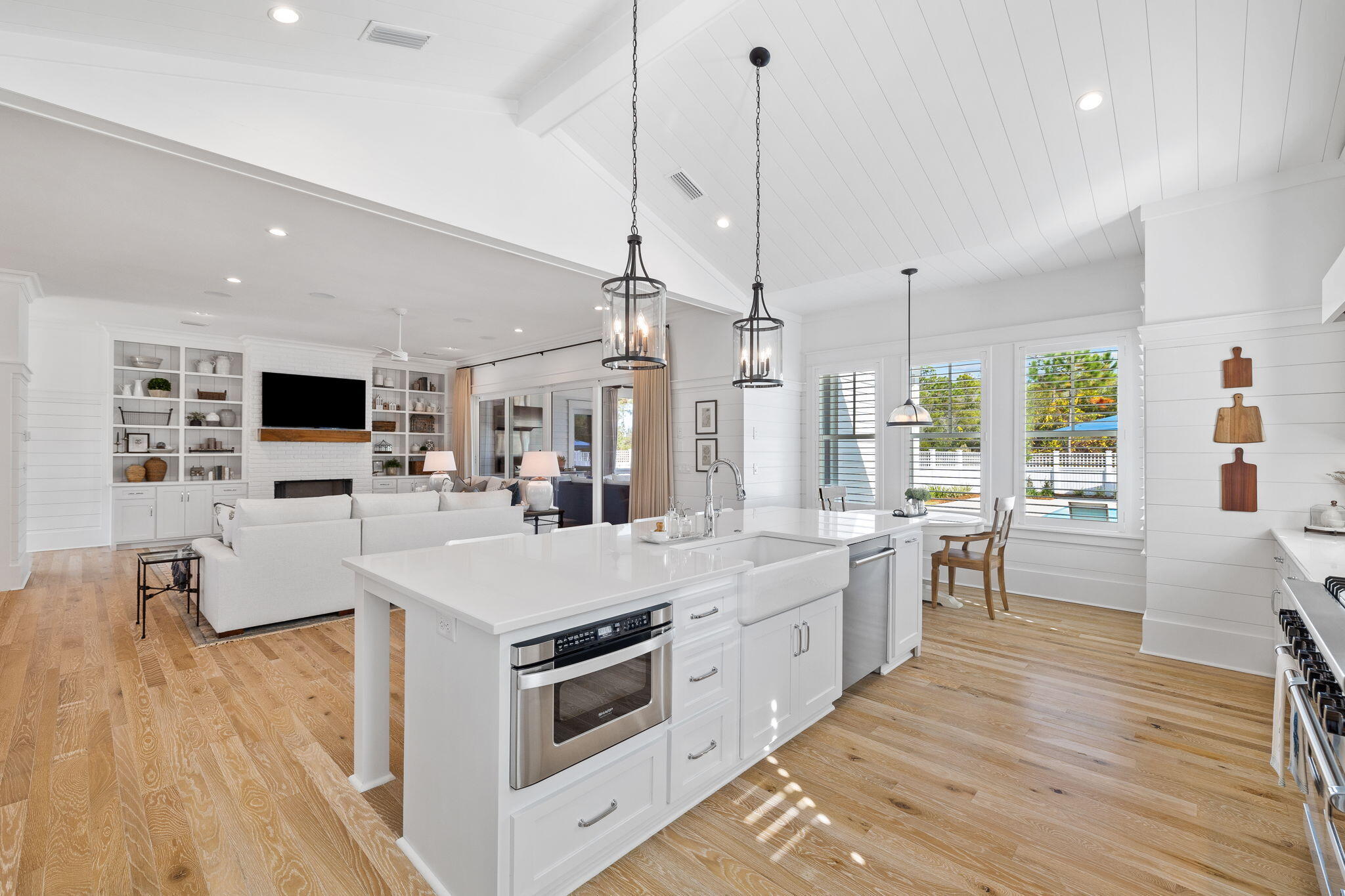 201 Needle Cast Ln Inlet Beach Inlet Beach, FL 32461 - Photo 40 of 92 a large kitchen with stainless steel appliances kitchen island a large counter tops a stove a chimney a sink and a living room view