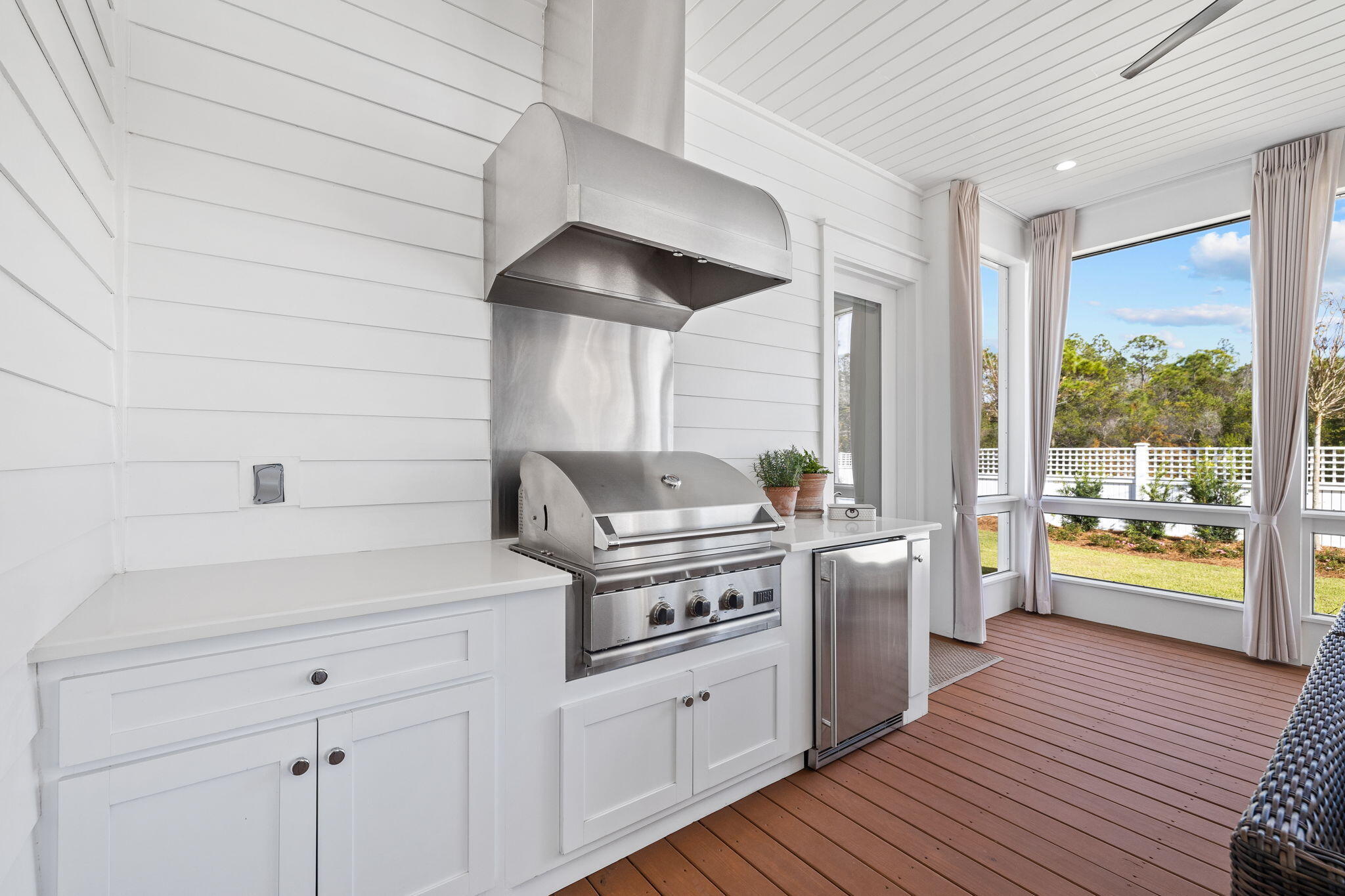 201 Needle Cast Ln Inlet Beach Inlet Beach, FL 32461 - Photo 44 of 92 a kitchen with stainless steel appliances a stove a sink and white cabinets with wooden floor