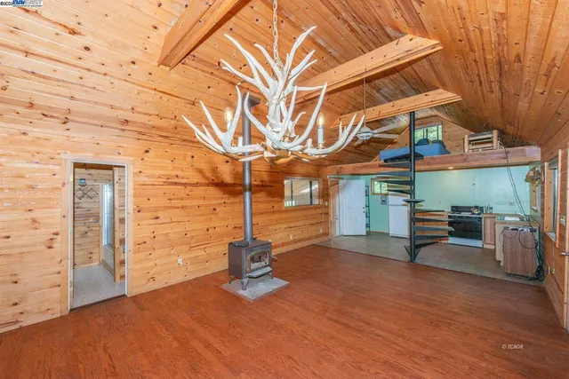 a backyard of a house with barbeque oven table and chairs