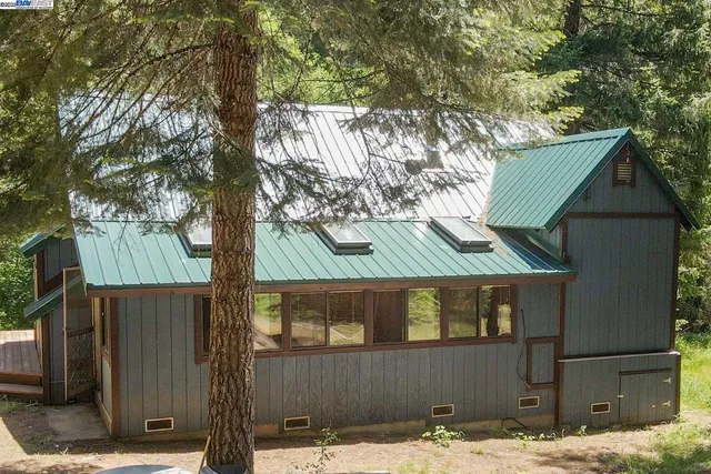 a view of a house with backyard and wooden floor