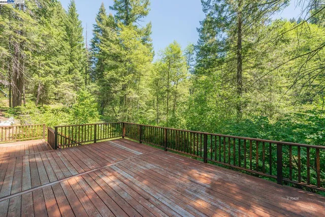 a view of balcony with wooden floor and fence