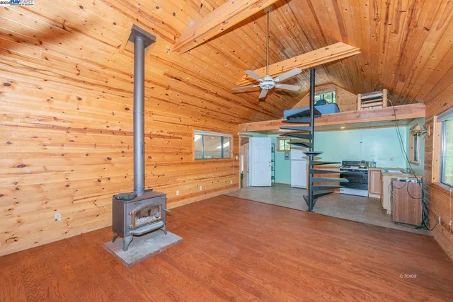 a view of a porch with furniture and a yard