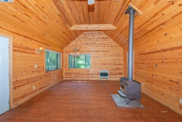 a view of a porch with wooden floor and iron fence