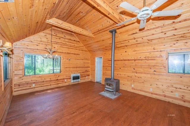 a view of a patio with table and chairs with wooden floor and fence