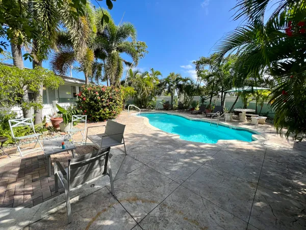 a view of a backyard with sitting area