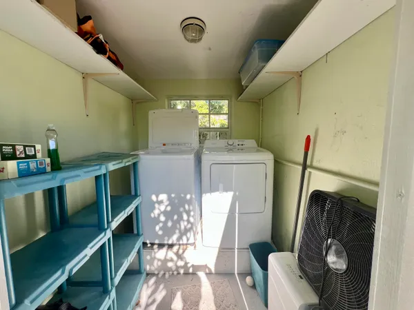 a view of a house with a yard and potted plants