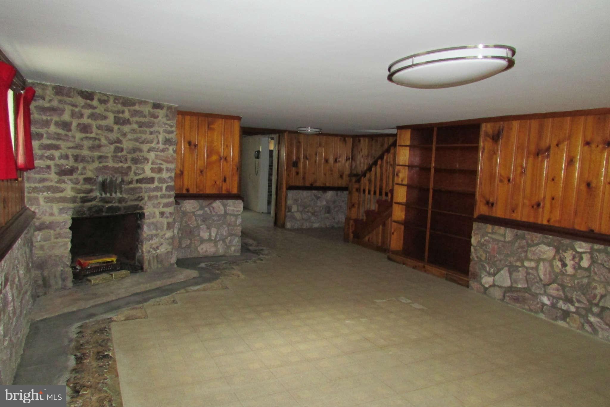 9217 Baltimore Road Frederick, MD 21704 - Photo 17 of 26 Rec room with stone fireplace