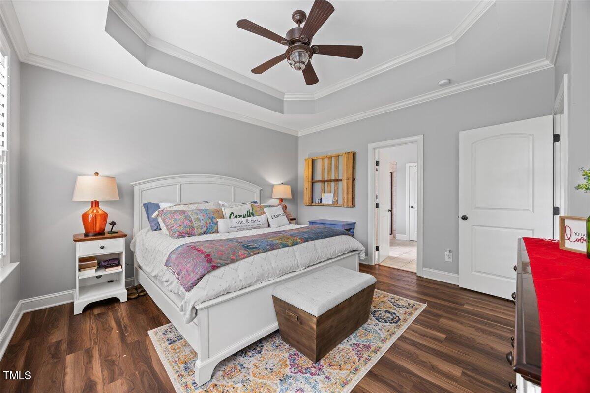 1300 Formal Garden Way Raleigh, NC 27603 - Photo 19 of 45 a bedroom with a bed and a chandelier