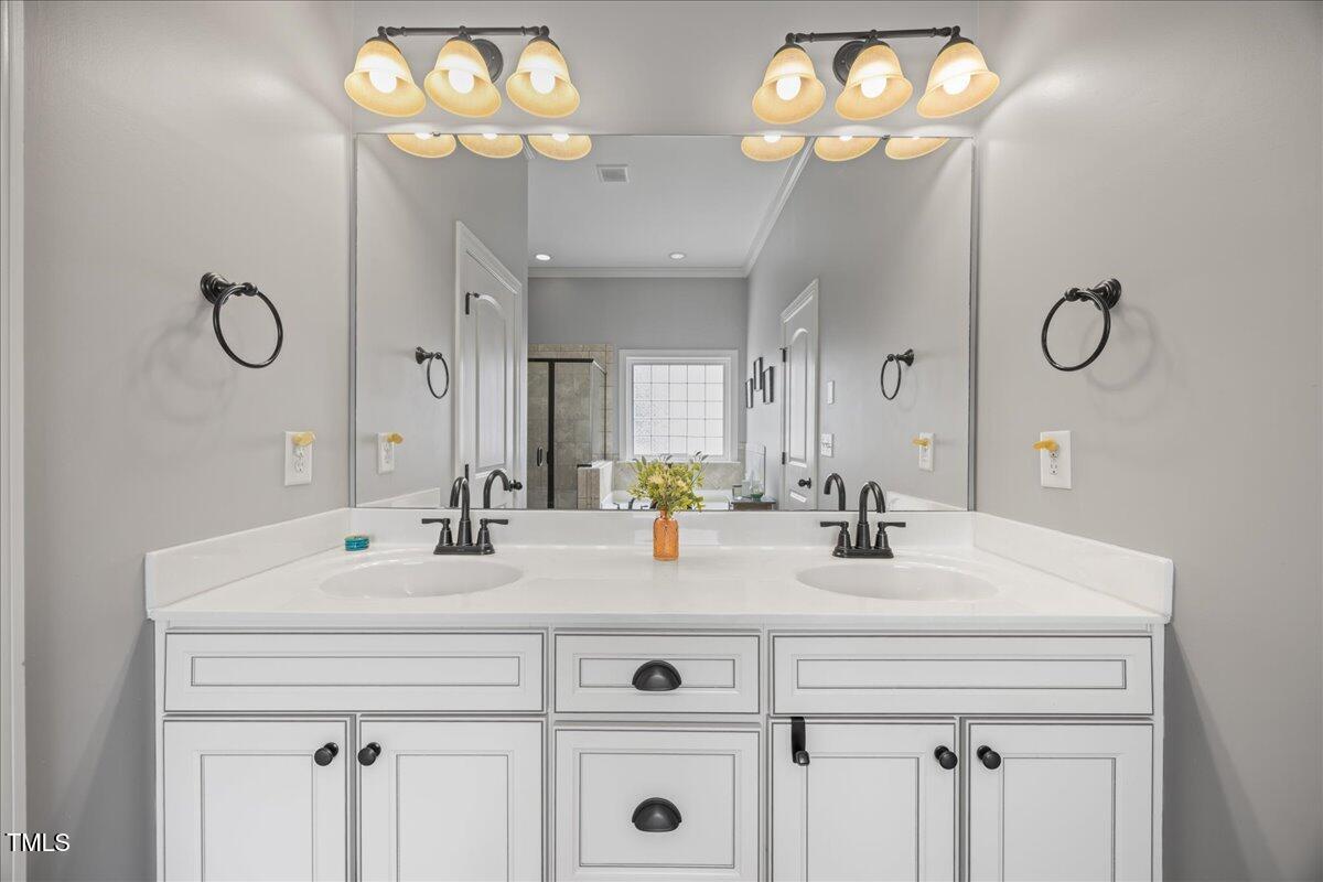 1300 Formal Garden Way Raleigh, NC 27603 - Photo 20 of 45 a bathroom with double vanity and a mirror