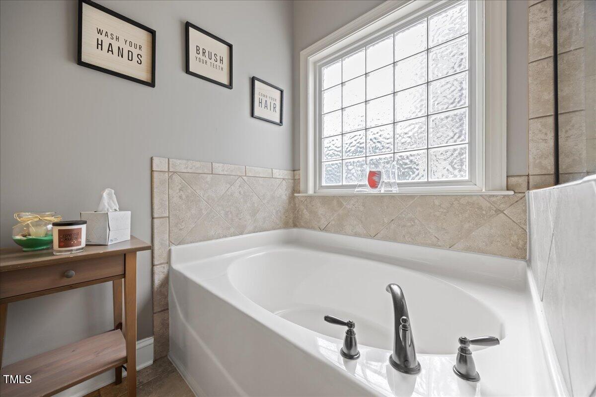 1300 Formal Garden Way Raleigh, NC 27603 - Photo 21 of 45 a bath tub sitting next to a window