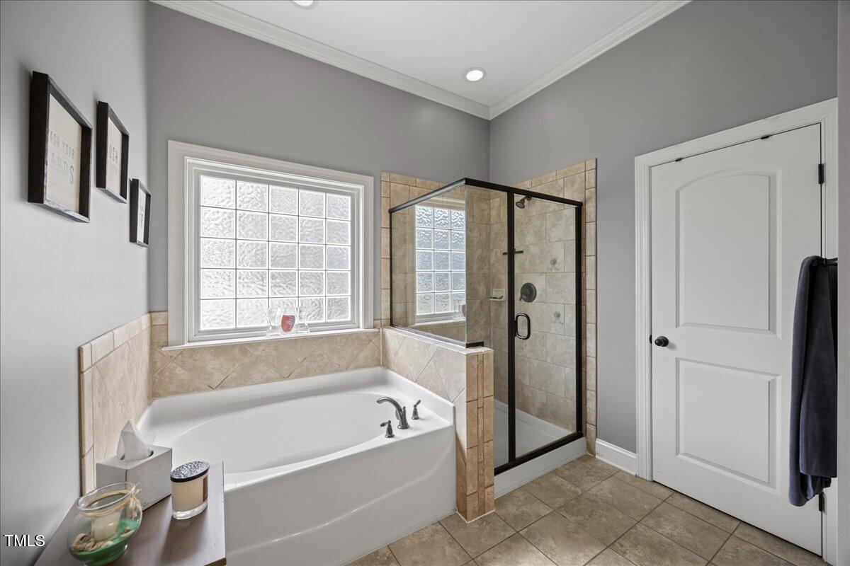 1300 Formal Garden Way Raleigh, NC 27603 - Photo 22 of 45 a bathroom with a bathtub and a shower