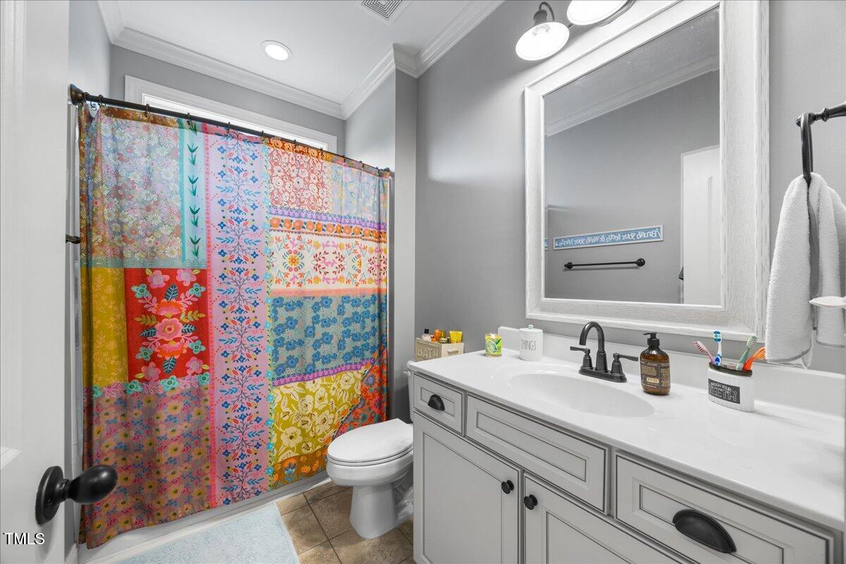 1300 Formal Garden Way Raleigh, NC 27603 - Photo 27 of 45 a bathroom with a sink a toilet and shower curtain