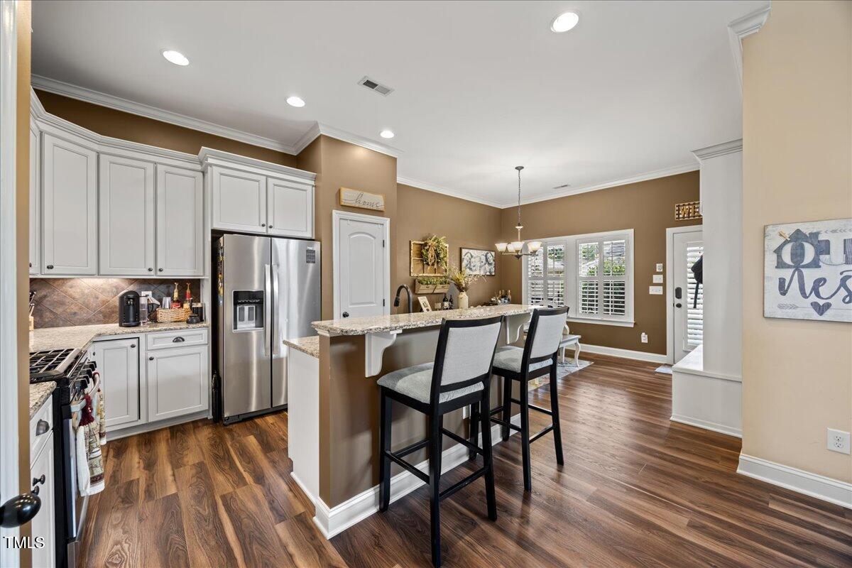 1300 Formal Garden Way Raleigh, NC 27603 - Photo 7 of 45 a kitchen with refrigerator a sink and chairs