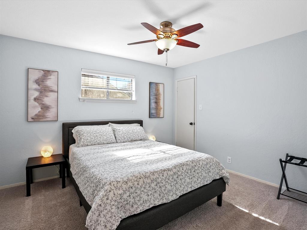 516 South Alabama Street Celina, TX 75009 - Photo 19 of 31 a bedroom with a bed and a chandelier