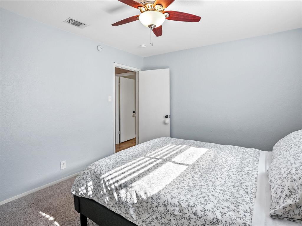 516 South Alabama Street Celina, TX 75009 - Photo 20 of 31 a bedroom with bed and a chandelier