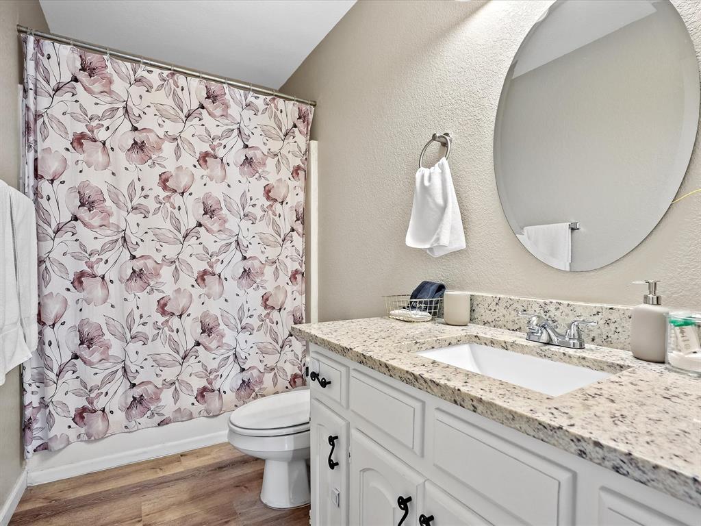 516 South Alabama Street Celina, TX 75009 - Photo 21 of 31 a bathroom with a granite countertop sink a toilet and a mirror