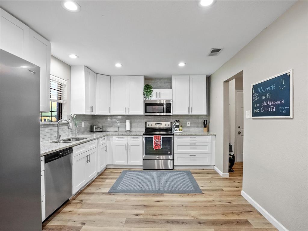 516 South Alabama Street Celina, TX 75009 - Photo 6 of 31 a kitchen with stainless steel appliances granite countertop a stove and a refrigerator