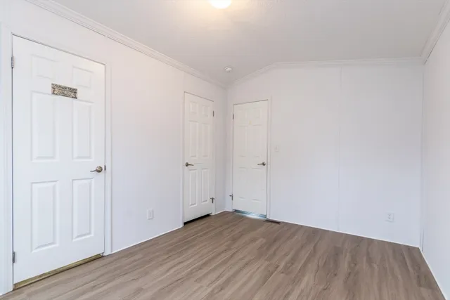 a view of an empty room and wooden floor
