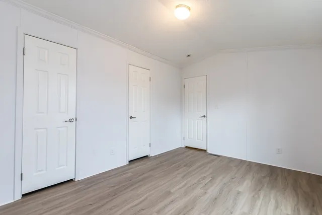 a view of a room with wooden floor