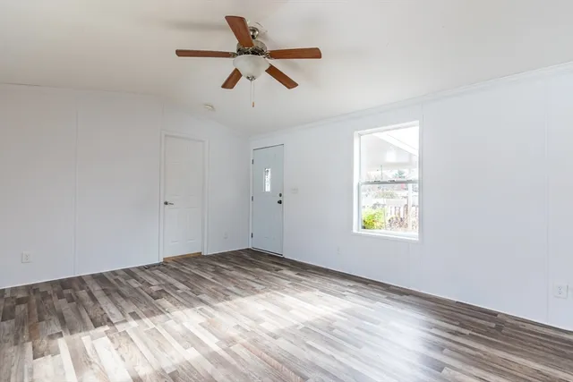 wooden floor in an empty room with a window