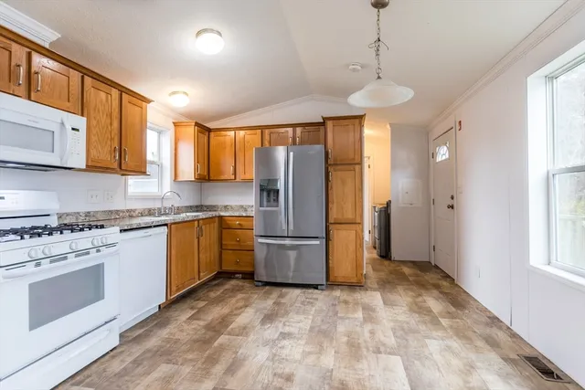 a kitchen with a stove a refrigerator and a sink