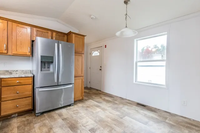 a kitchen with stainless steel appliances granite countertop a refrigerator and a stove top oven