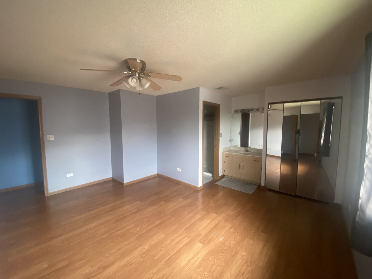 10516 Ridge Cove Drive, Unit 36C Chicago Ridge, IL 60415 - Photo 12 of 16 a view of empty room with wooden floor and kitchen view
