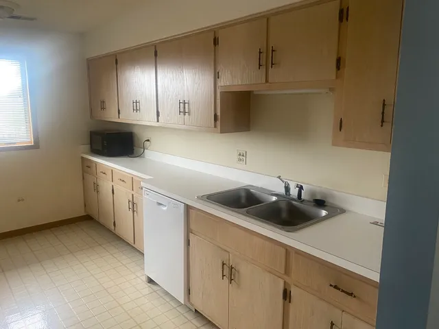 a kitchen with a sink and cabinets