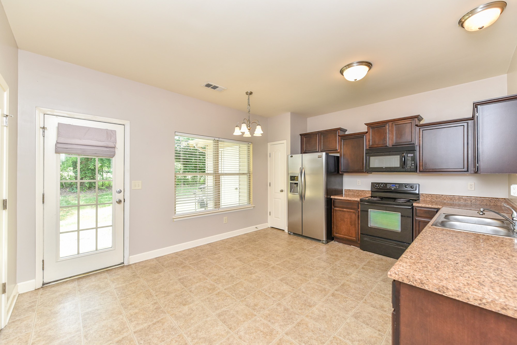 735 Tulip Grove Road, Unit 311 Hermitage, TN 37076 - Photo 14 of 35 a kitchen with stainless steel appliances granite countertop a stove a sink dishwasher a refrigerator and a oven with granite countertops
