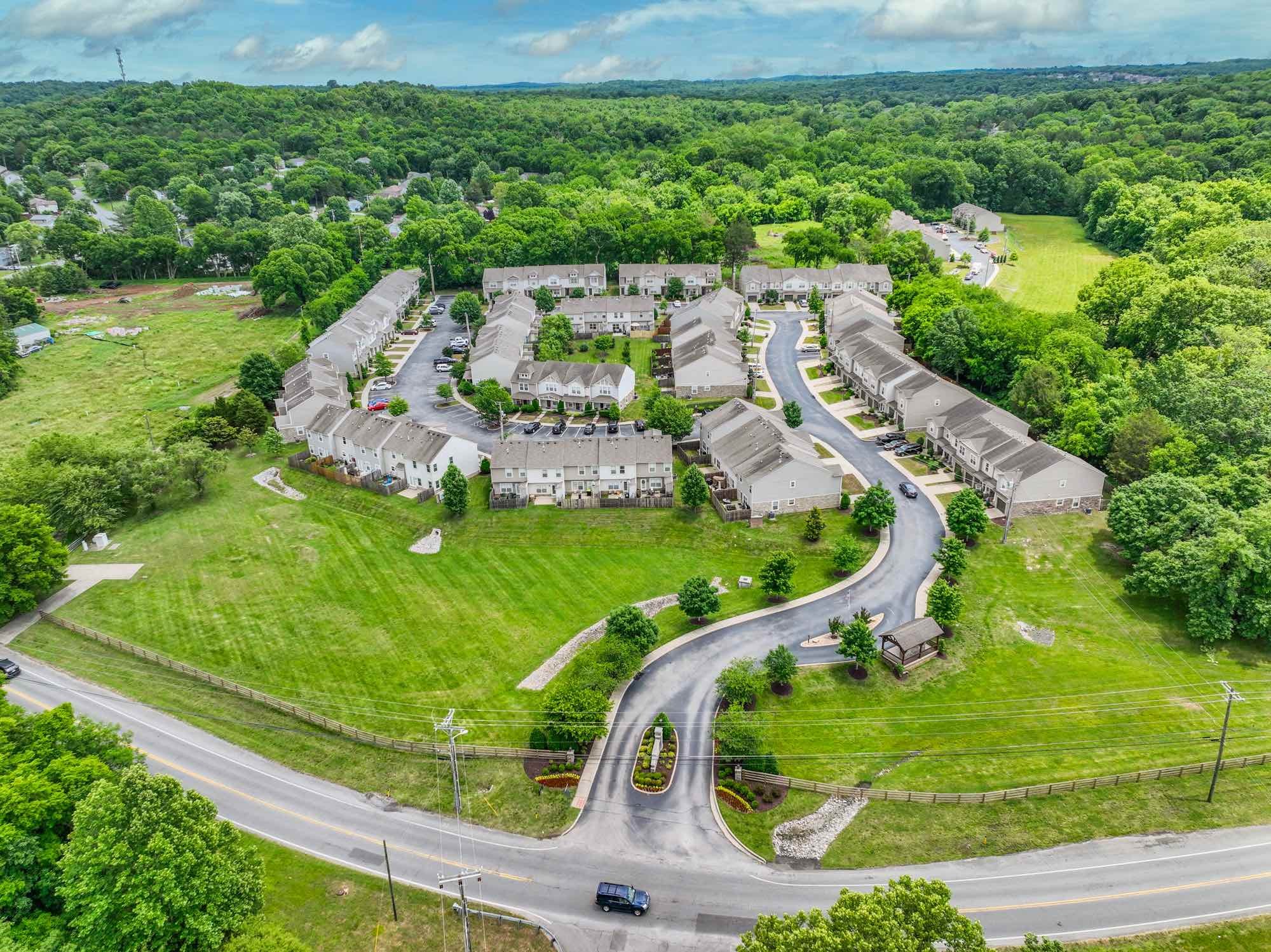 735 Tulip Grove Road, Unit 311 Hermitage, TN 37076 - Photo 26 of 35 an aerial view of a house with a garden and trees