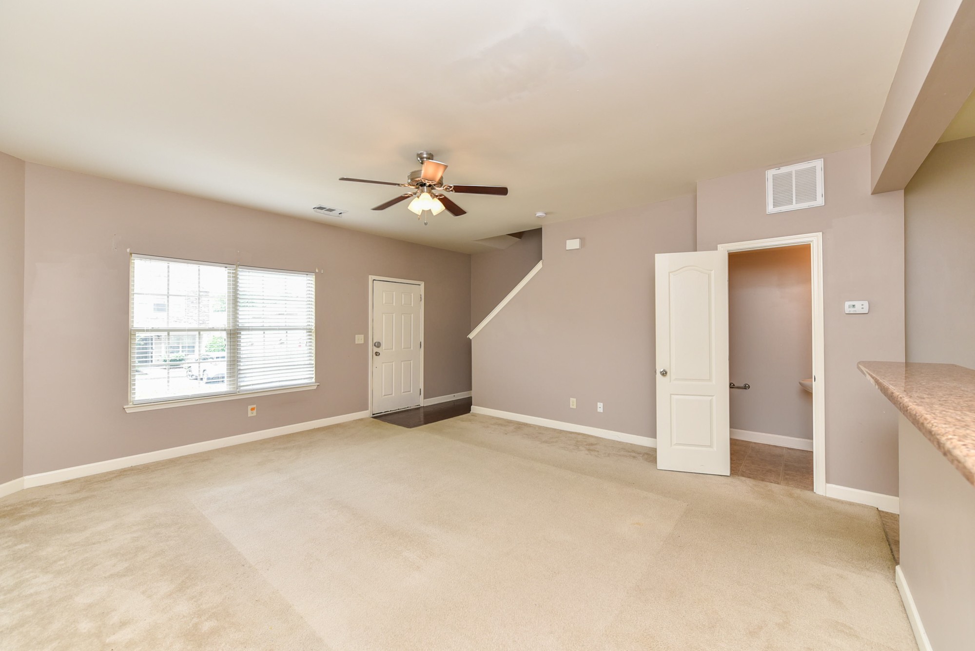 735 Tulip Grove Road, Unit 311 Hermitage, TN 37076 - Photo 7 of 35 an empty room with windows and ceiling fan