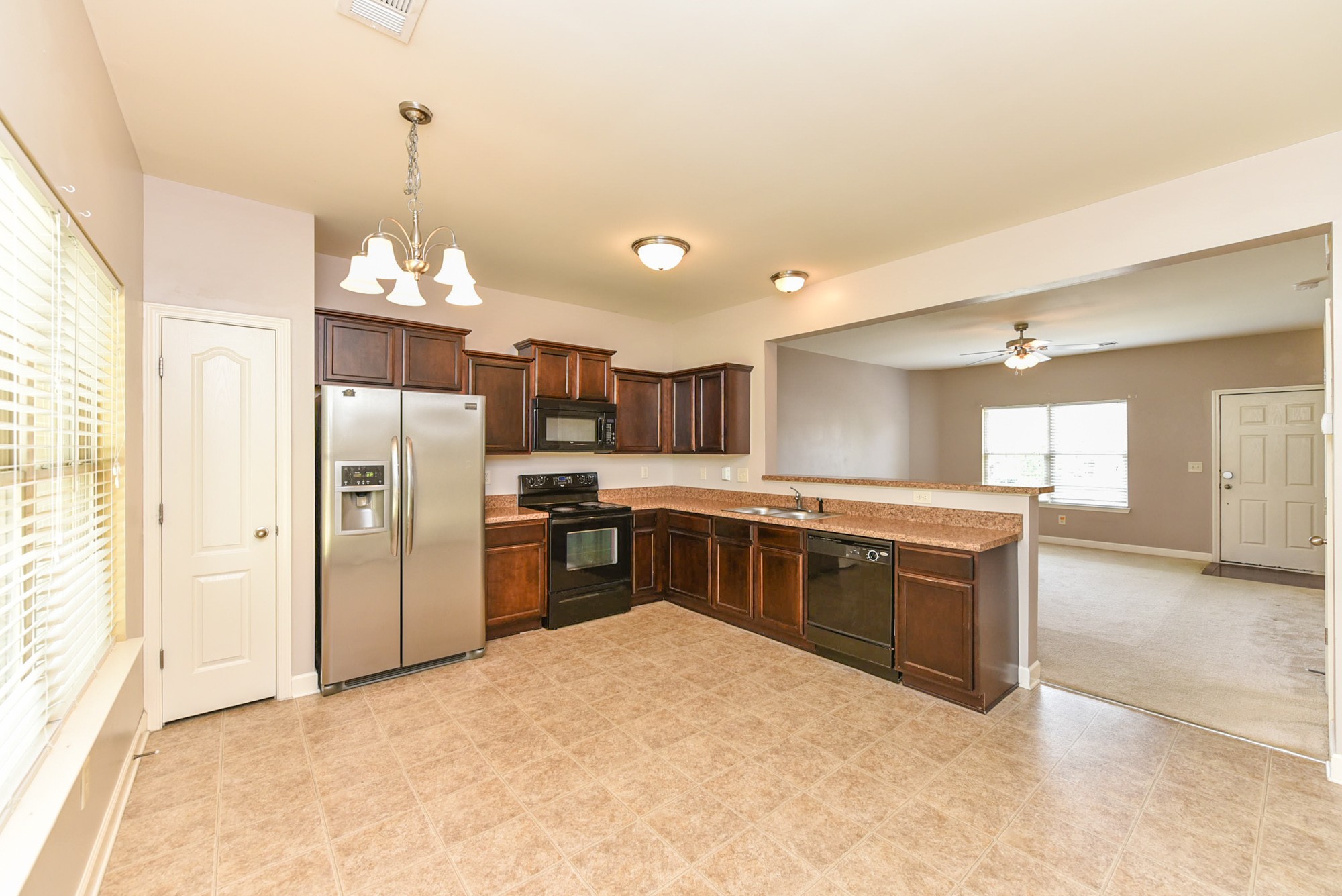 735 Tulip Grove Road, Unit 311 Hermitage, TN 37076 - Photo 9 of 35 a large kitchen with stainless steel appliances kitchen island granite countertop a refrigerator and a sink